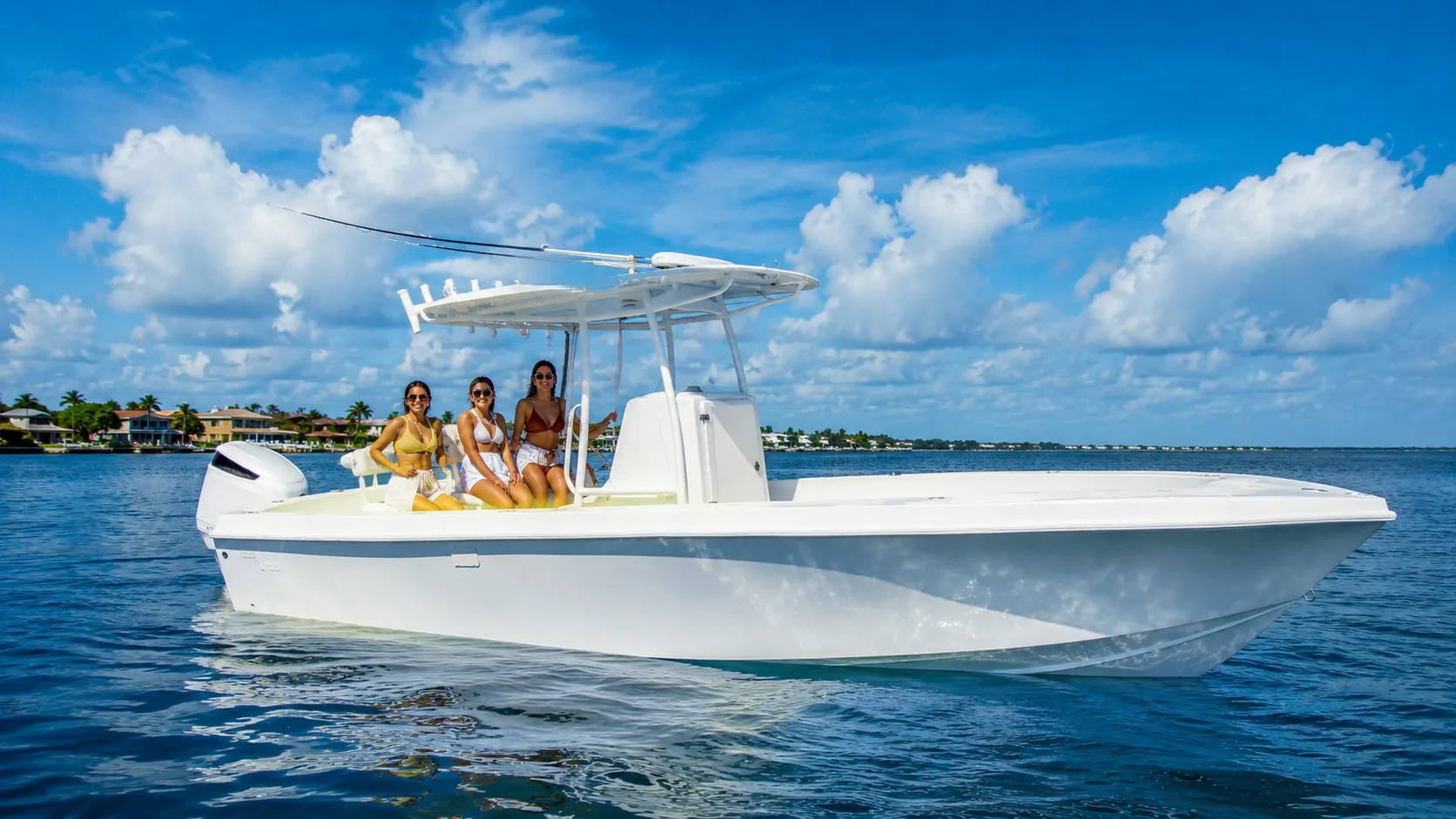 Center-console fishing boat idling on calm water near the coast